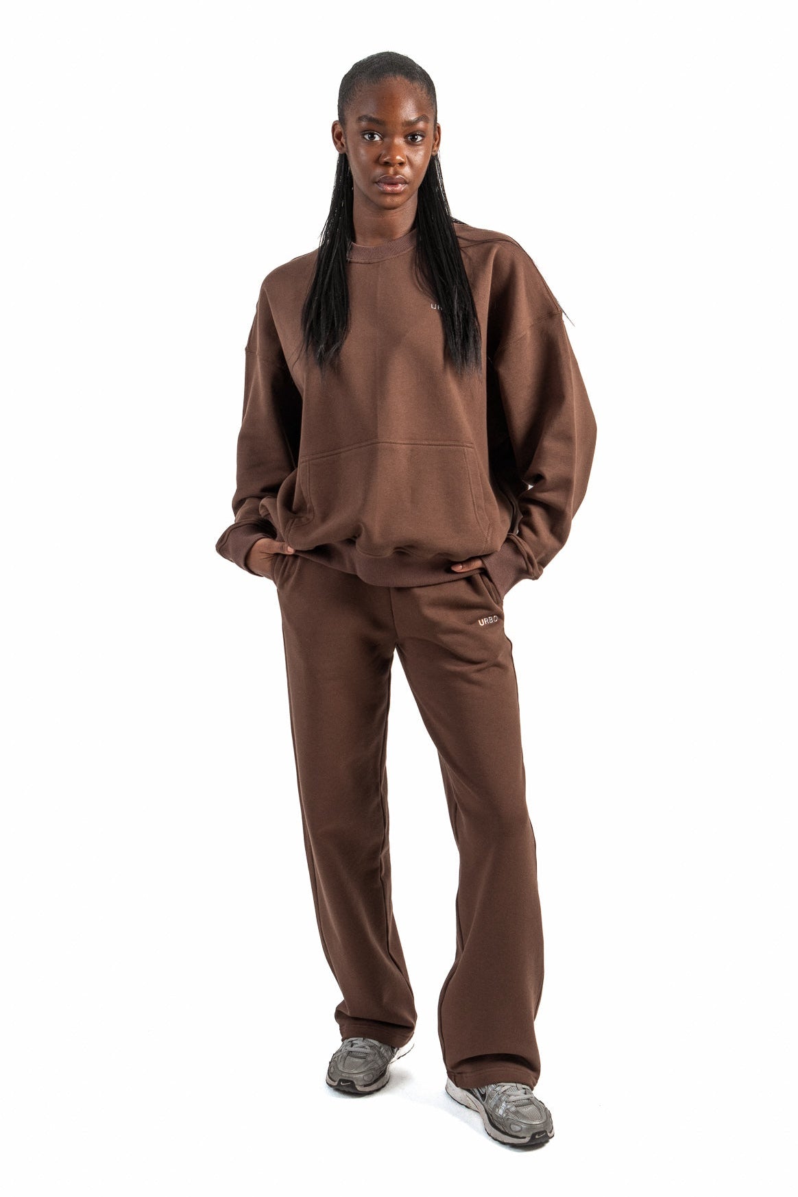 Person wearing a brown outfit on a white background