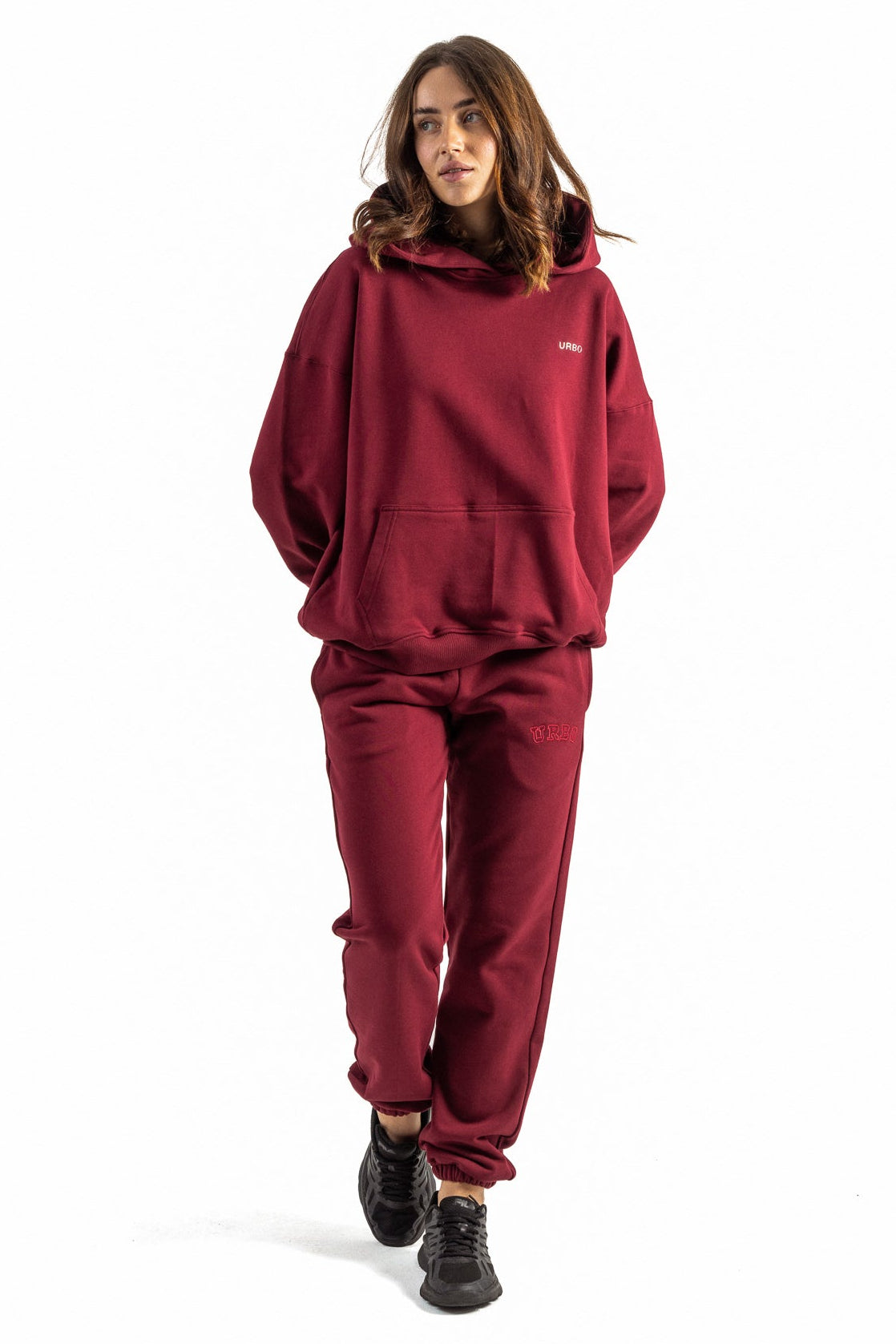 Person wearing a red tracksuit on a white background