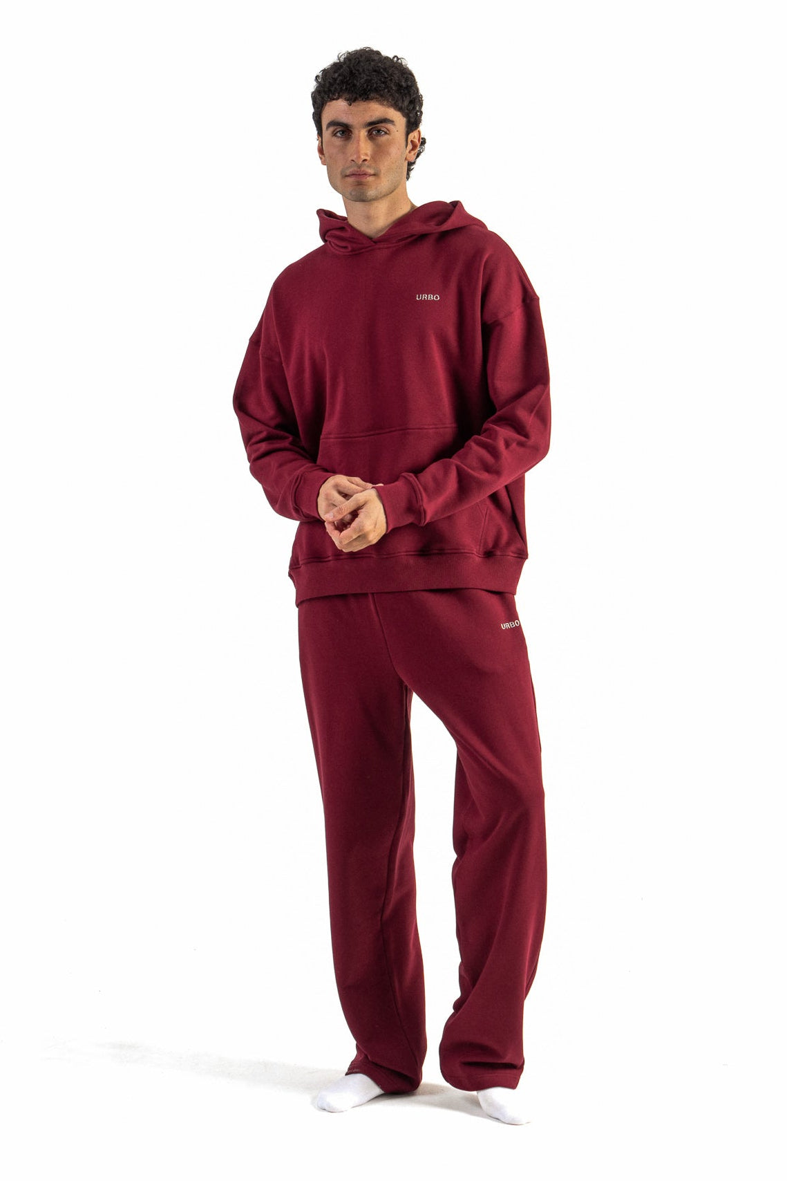 Man wearing a red tracksuit on a white background