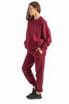 Woman wearing a red tracksuit on a white background
