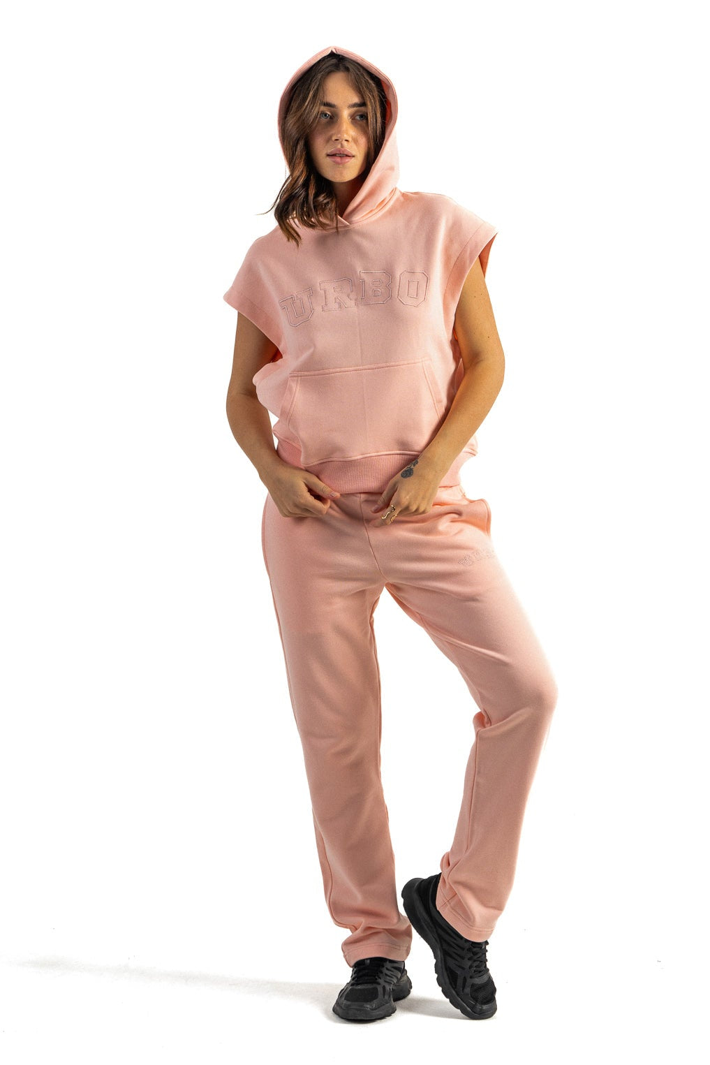 Person wearing a pink outfit on a white background