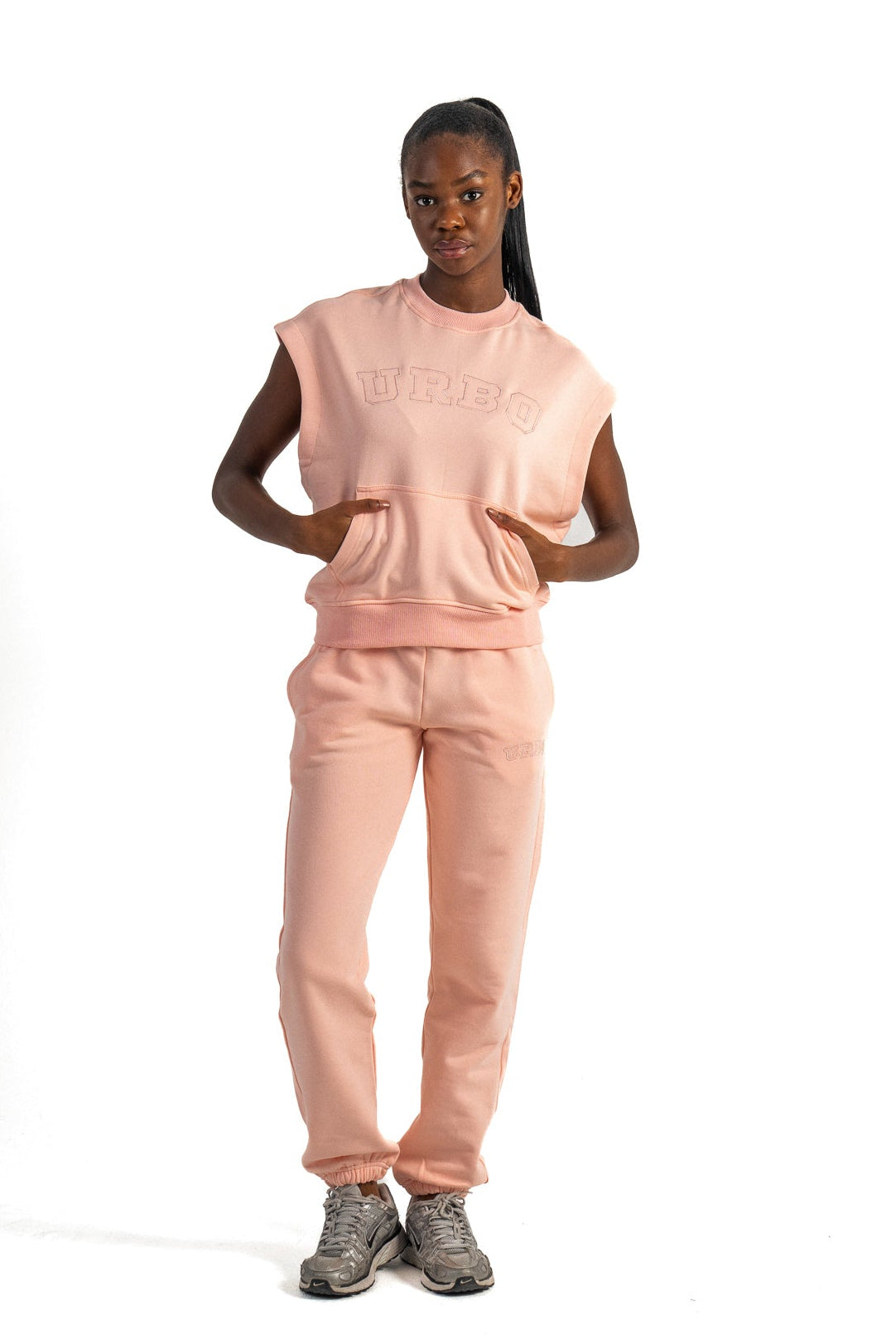 Person wearing a pink outfit with 'Bellaire' branding on a white background