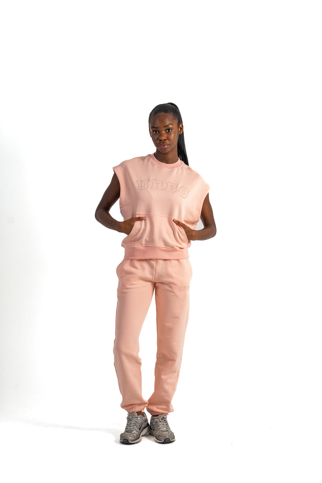 Person wearing a pink outfit with 'Bellaire' branding on a white background