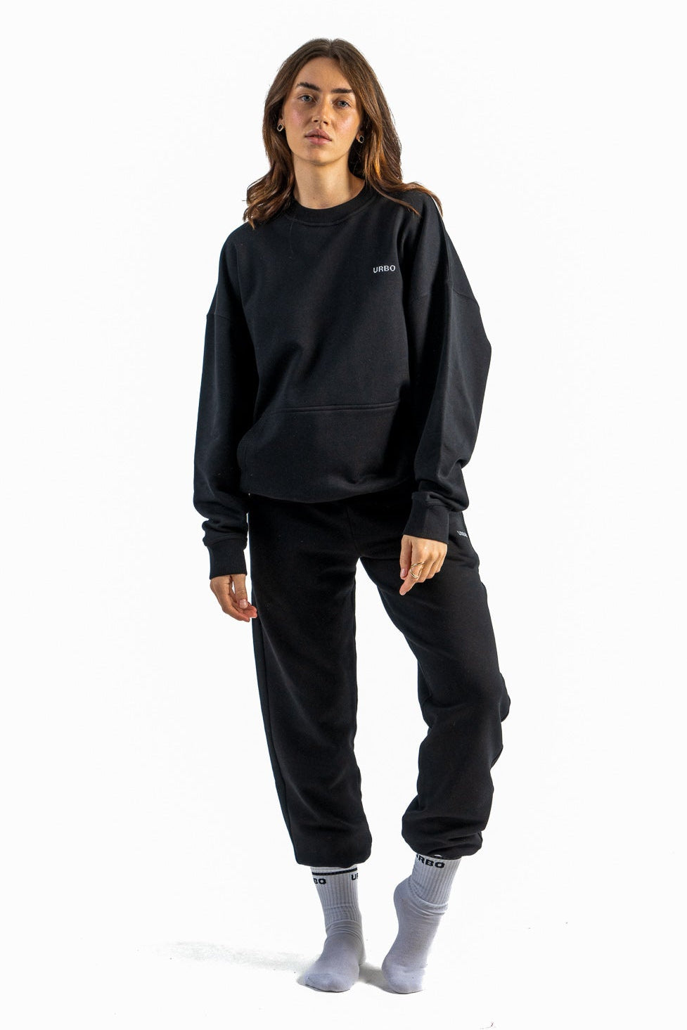 Person wearing a black outfit on a white background