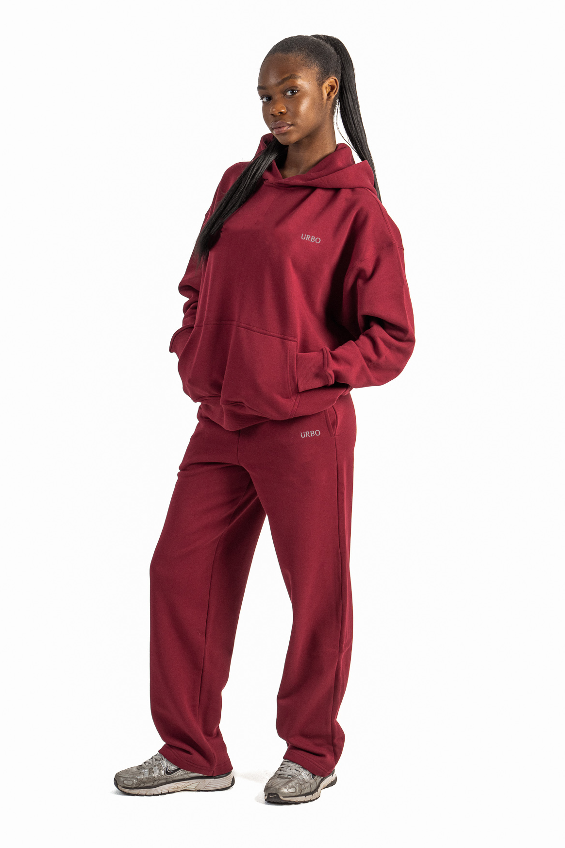 Person wearing a red tracksuit on a white background