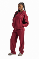 Person wearing a red tracksuit on a white background